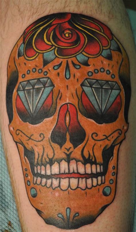 Sugar skull tattoo on thigh - Bull Skull Tattoo. Bull skulls are a popular symbol in tattooing, often representing strength, power, and determination. They can make for a very striking tattoo design, and can be adapted to fit any style. These tattoos are often very detailed, with intricate designs and lots of shading. 2. Sugar Skull Tattoo.